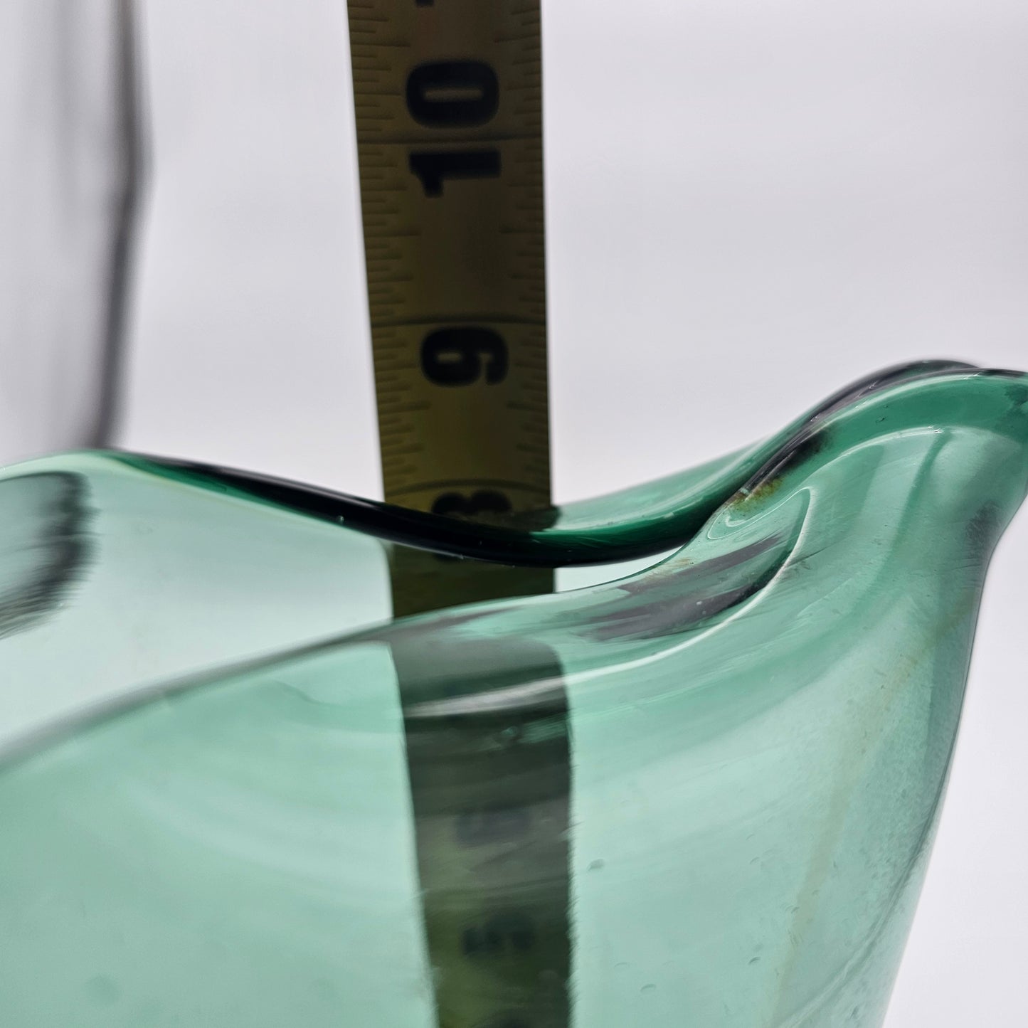 Hand blown pinched spout green glass pitcher