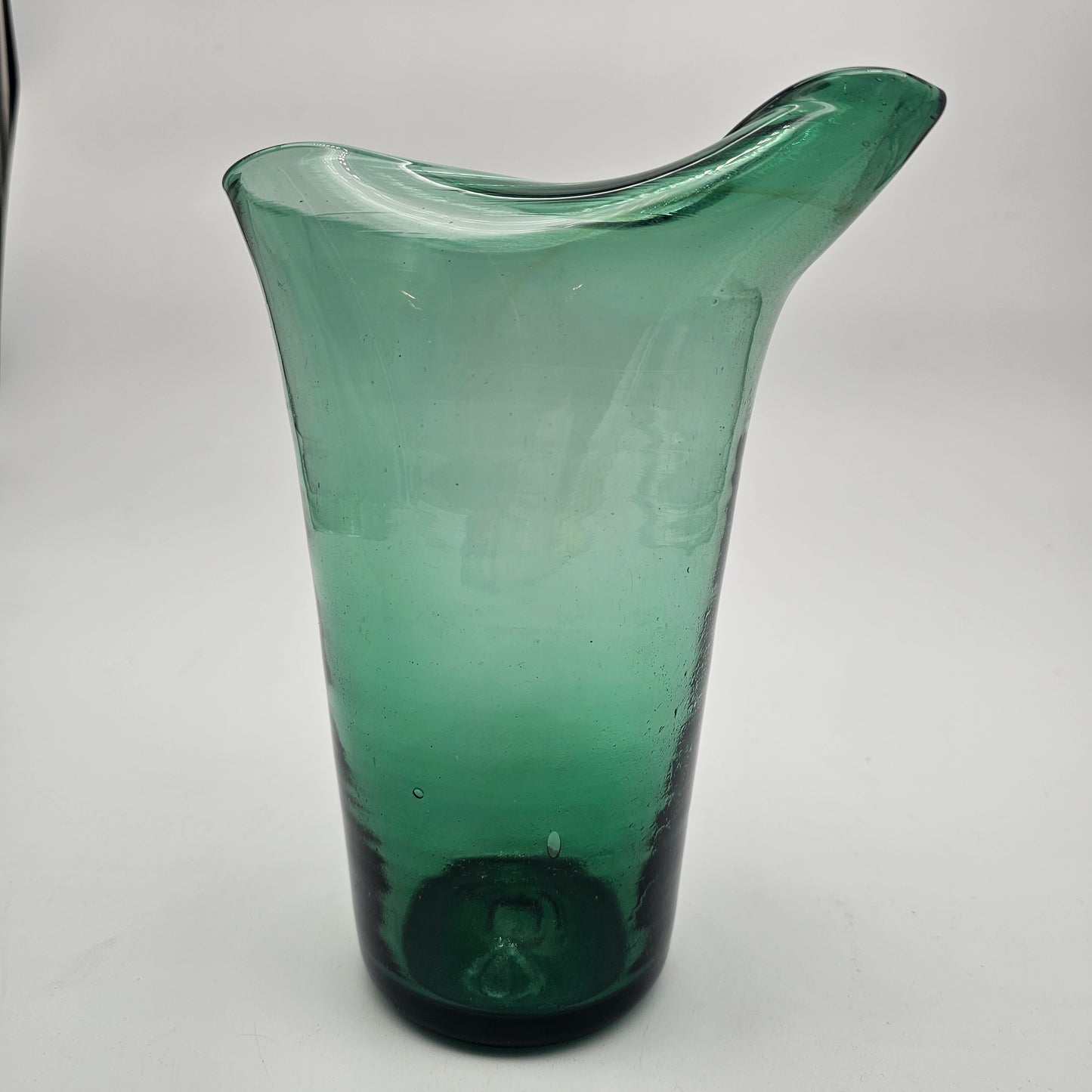 Hand blown pinched spout green glass pitcher