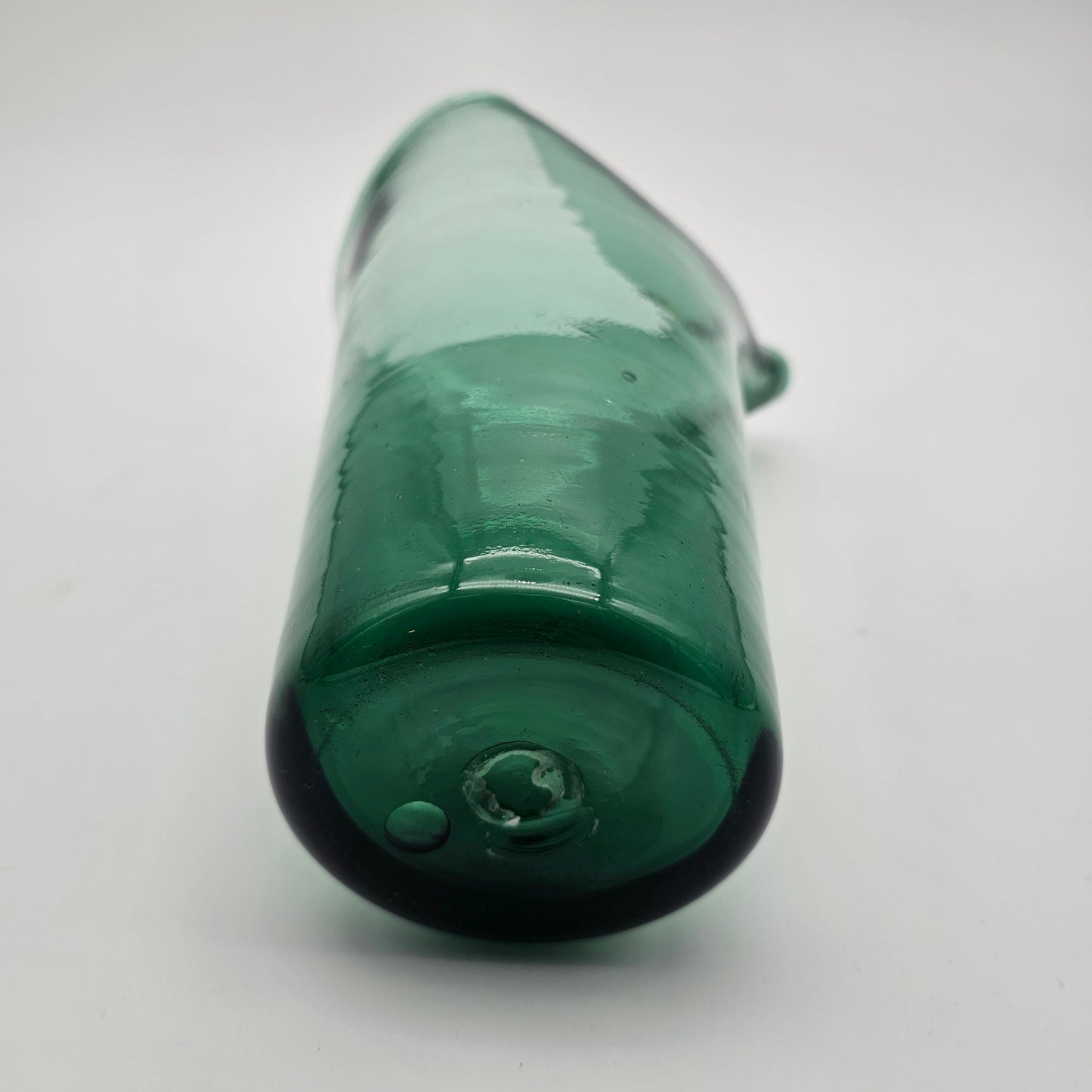 Hand blown pinched spout green glass pitcher